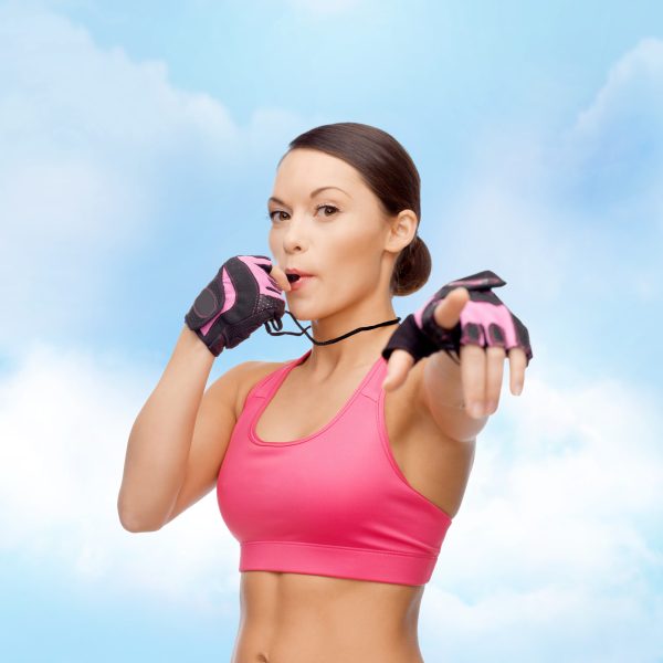 sport, fitness and healthcare concept - beautiful asian personal trainer with whistle